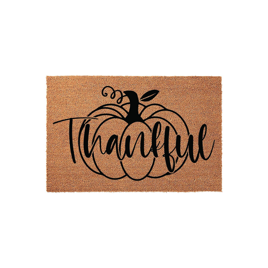 Thankful Pumpkin Fall Doormat featuring a natural coir texture with a bold black graphic of a large pumpkin and the word Thankful written in elegant script, creating a festive autumn entryway decor piece for your front porch or
