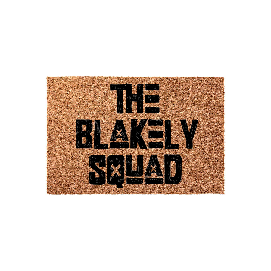 Personalized family name coir doormat featuring the text The Squad in a bold, distressed black font against a natural tan coconut fiber background, creating a rustic and welcoming entrance piece for any modern home front porch.