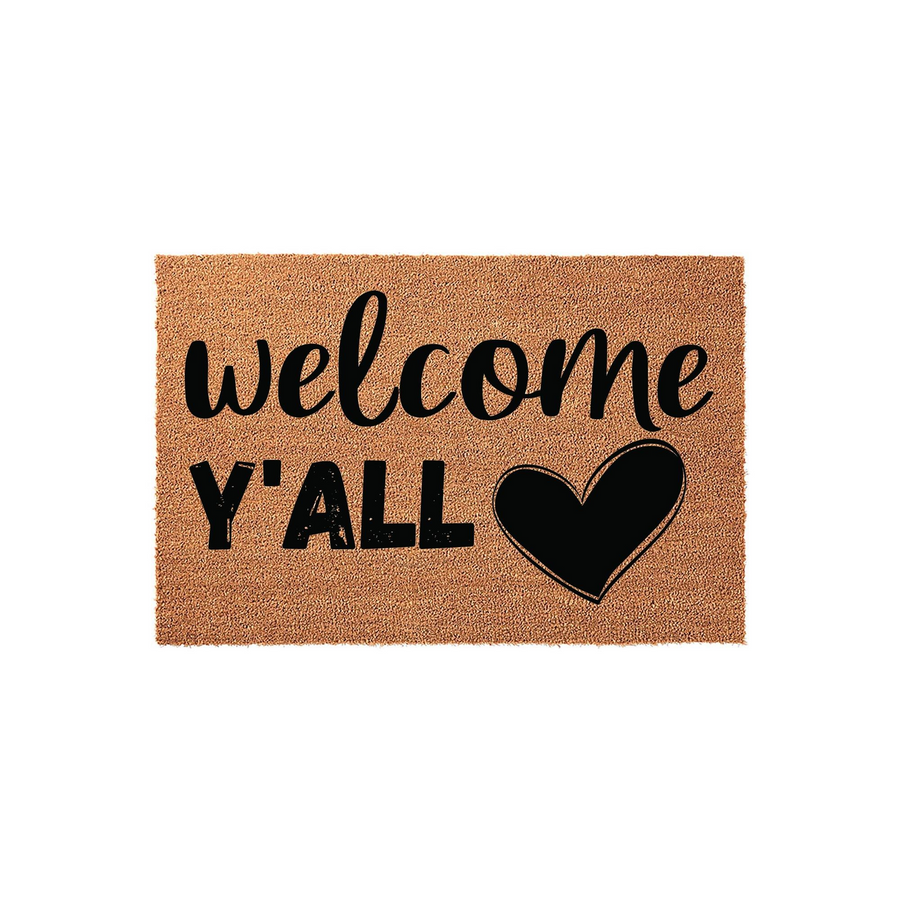 Welcome Y'all coir doormat featuring a rustic natural fiber texture with bold black lettering and a heart icon, providing a warm and inviting farmhouse style entrance decor for your front porch or home entryway on a plain white
