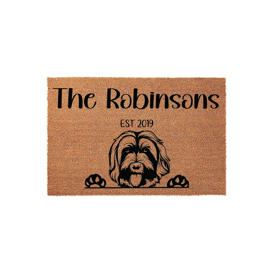 Personalized Doodle dog doormat featuring a cute shaggy dog illustration with paws resting at the bottom, customized with a family name and established year on a natural tan coir fiber background for a welcoming front porch