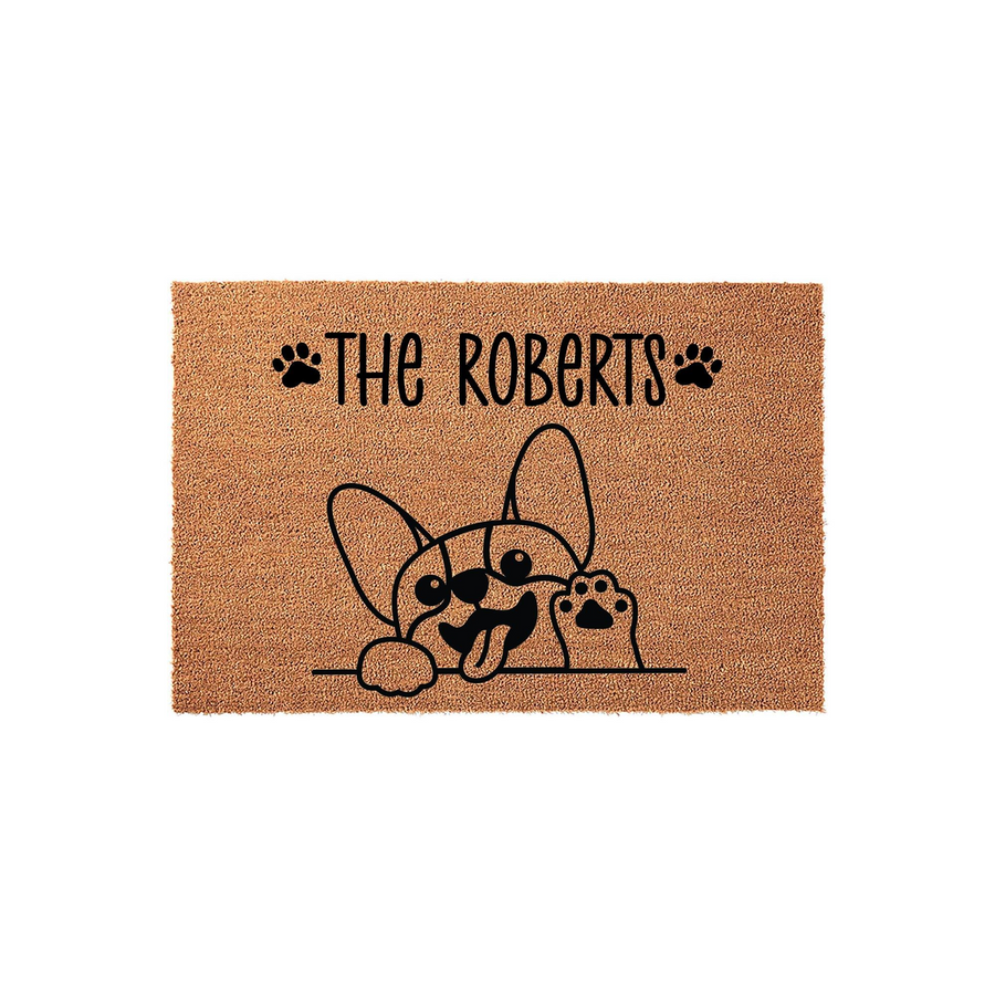 Personalized French Bulldog doormat featuring a cute dog peeking over a line with a paw raised, printed on natural coir fiber with a custom family name and paw print accents for a welcoming and charming front porch entryway decor.