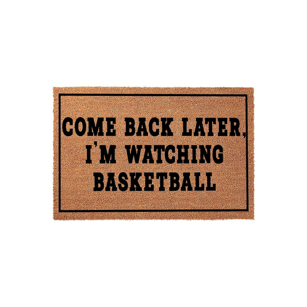 Come Back Later I'm Watching Basketball coir doormat featuring bold black text centered on a natural brown fiber background, perfect for a sports fan's front porch entrance to keep visitors away during the big game.