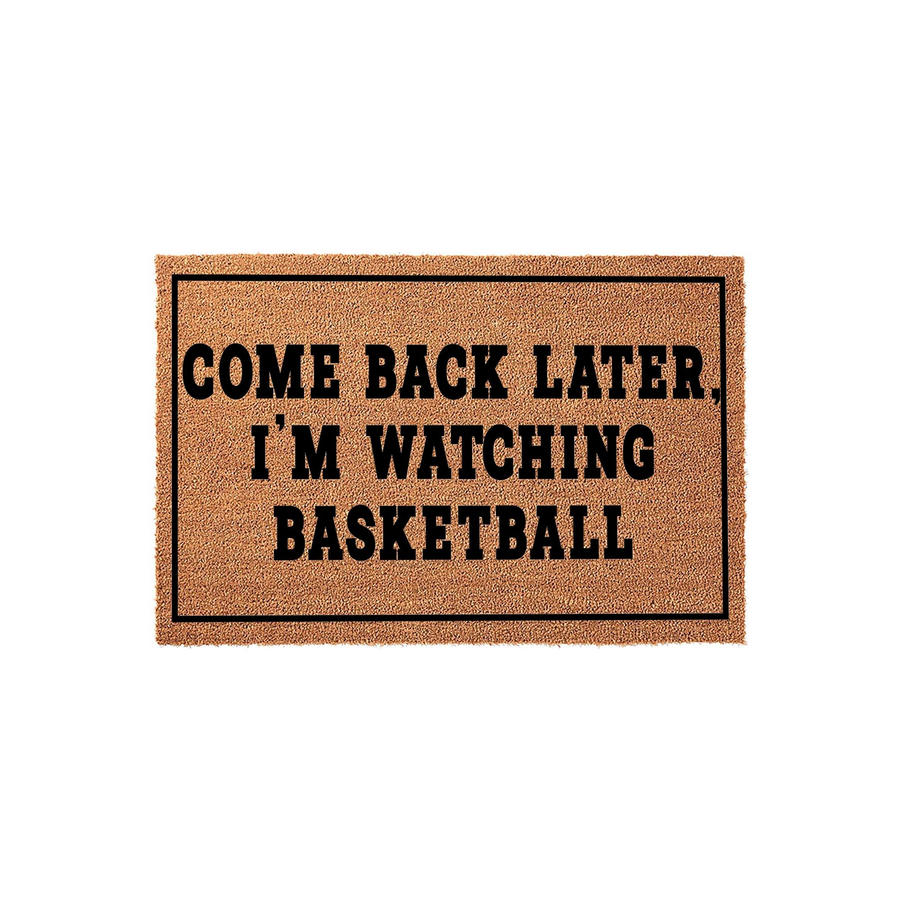 Come Back Later I'm Watching Basketball coir doormat featuring bold black text centered on a natural brown fiber background, perfect for a sports fan's front porch entrance to keep visitors away during the big game.