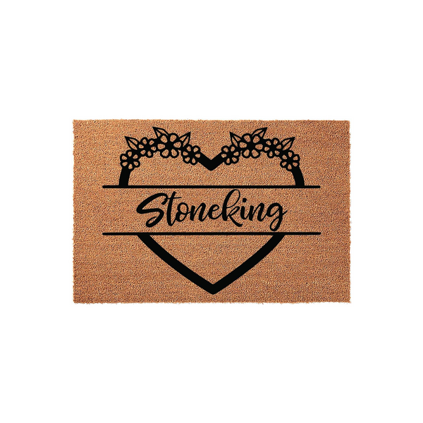 Personalized floral heart coir doormat featuring a decorative black heart outline topped with flowers and a central space for a custom family name, set against a natural brown textured coir background for a welcoming home