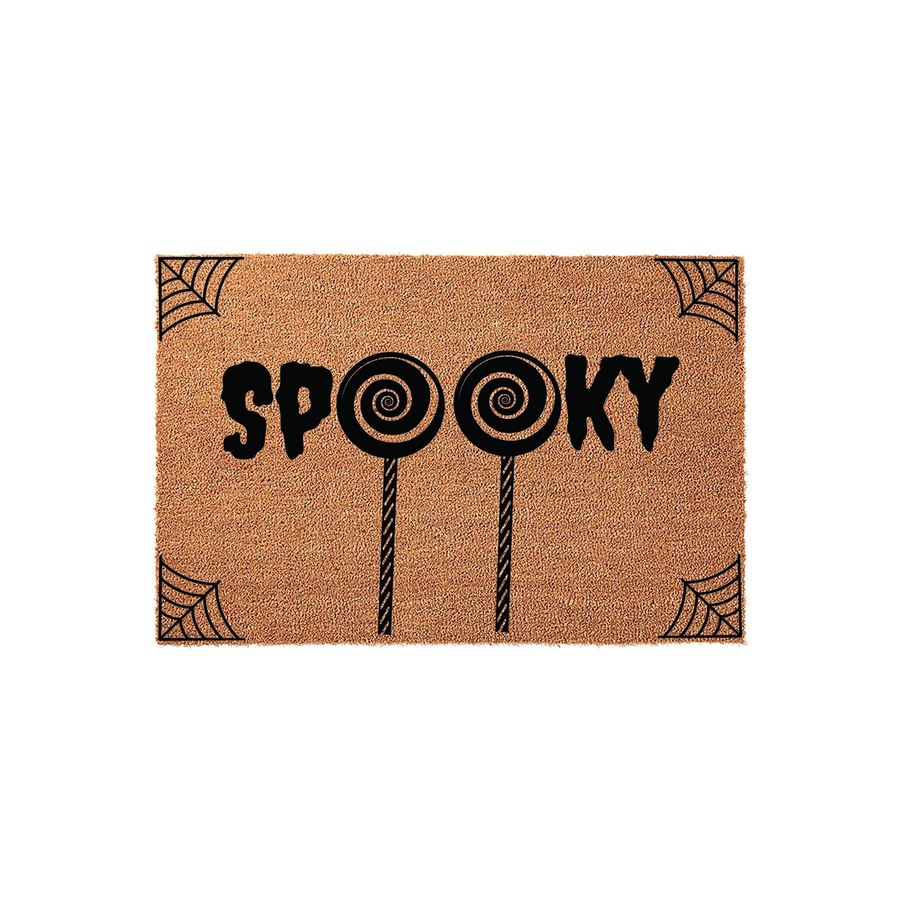 Spooky Halloween doormat featuring a natural coir texture with black text that spells out Spooky, using two lollipop icons for the letter O, and decorative spider web corner accents on a plain white studio background for seasonal