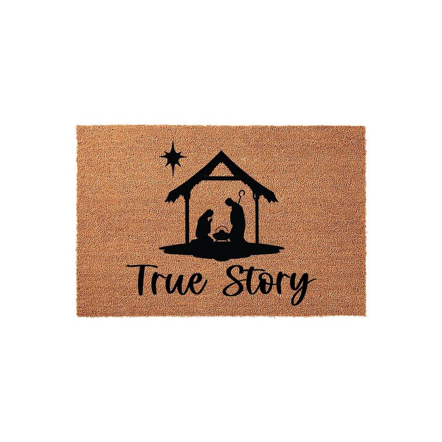 Nativity Scene Christmas Doormat featuring a black silhouette of the holy family in a stable with a star above and the words True Story written in elegant script on a natural brown coir fiber background for holiday porch decor.
