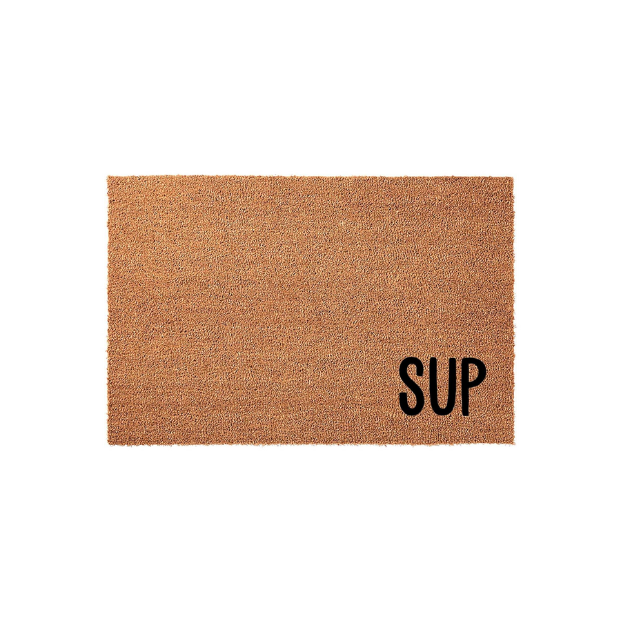 SUP Coir Doormat featuring a natural brown fiber texture and bold black lettering in the bottom right corner, providing a casual and modern welcome for your front porch or entryway on a clean white studio background.
