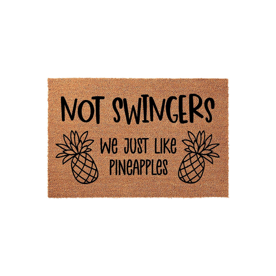 Funny Pineapple Welcome Doormat featuring natural coir fibers and bold black text that reads Not Swingers We Just Like Pineapples, complete with two illustrated pineapple icons on a plain white studio background for a humorous
