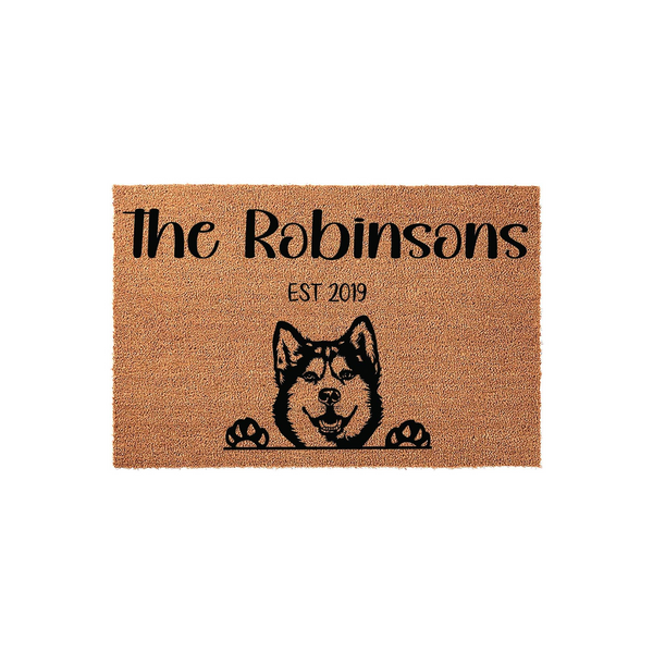 Personalized Husky Dog Doormat featuring a natural coir texture with a black printed illustration of a smiling Husky peeking over its paws, customized with a family name and established year on a clean white background.