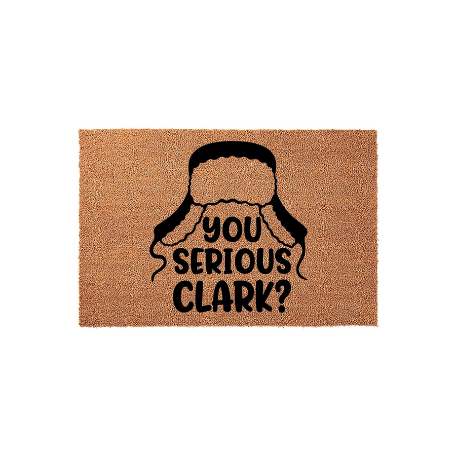 Funny Christmas doormat featuring a black graphic of a winter trapper hat and the text You Serious Clark, printed on a natural tan coir fiber mat that adds a festive and humorous touch to your holiday home entryway decor.