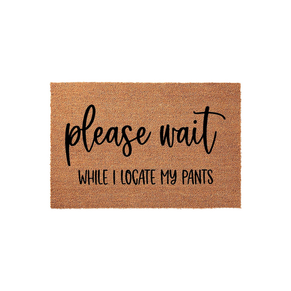 Funny Please Wait While I Locate My Pants doormat featuring bold black text printed on a natural brown coir fiber mat, creating a humorous and welcoming entrance decor piece for your home front porch or entryway floor.