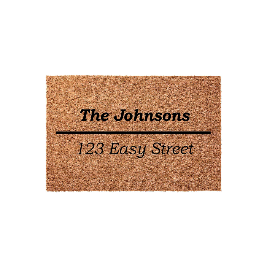Personalized family name coir doormat featuring a natural tan fiber texture with black printed text that displays a custom family name and address, creating a welcoming entrance for any home on a clean white studio background.