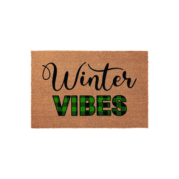Winter Vibes coir doormat featuring a natural brown fiber texture with the word Winter in elegant black script and the word VIBES in bold green and black buffalo plaid lettering for a festive seasonal front porch entryway decor.
