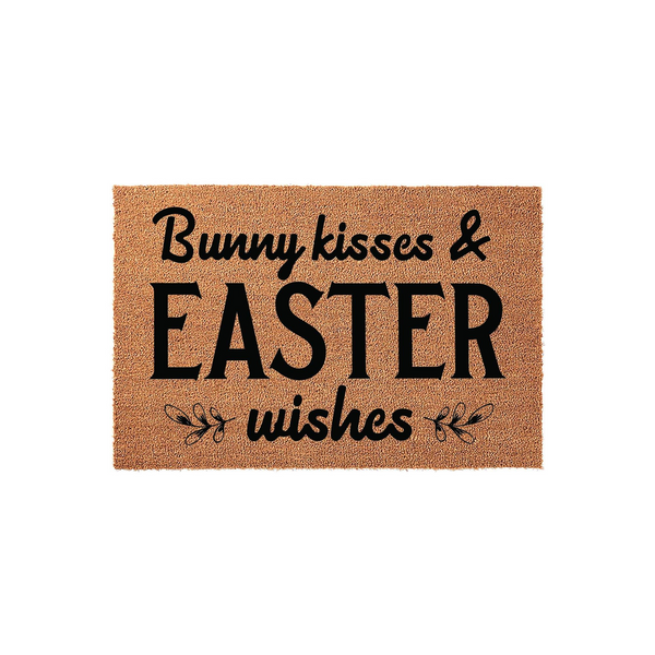 Bunny Kisses and Easter Wishes coir doormat featuring a natural brown fiber texture with bold black lettering and decorative floral accents, creating a festive spring entryway decor piece for your home during the holiday season.