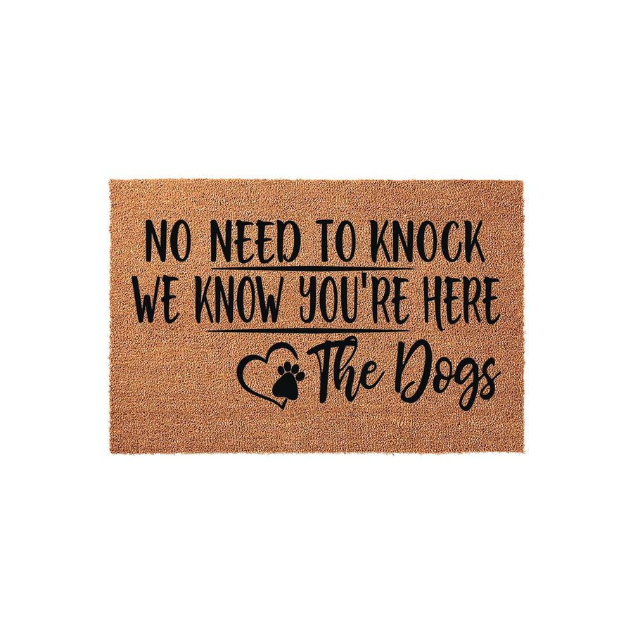 Funny Dog Welcome Doormat featuring a natural coir texture and bold black text that reads No Need To Knock We Know You Are Here The Dogs, complete with a cute paw print heart design for a charming entryway decor piece for pet