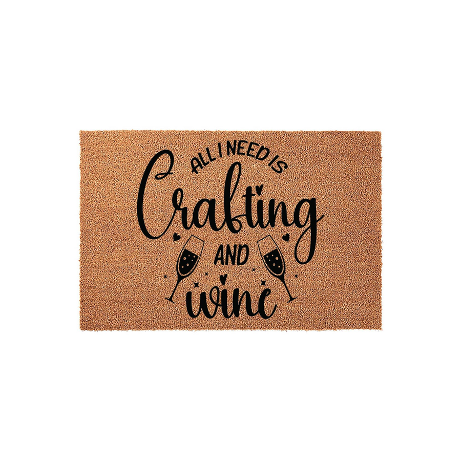 Crafting and Wine Coir Doormat featuring a natural brown fiber texture with black printed text that reads All I Need Is Crafting And Wine, accented by two illustrated wine glasses on a clean, isolated white studio background.