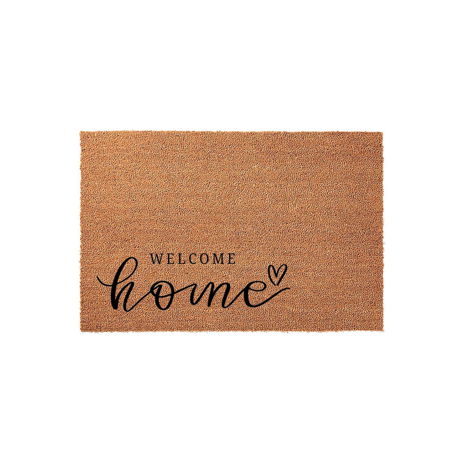 Welcome Home coir doormat featuring a natural tan fiber texture and elegant black typography that reads Welcome home with a small heart icon, providing a warm and inviting entrance for any front porch or entryway decor style.