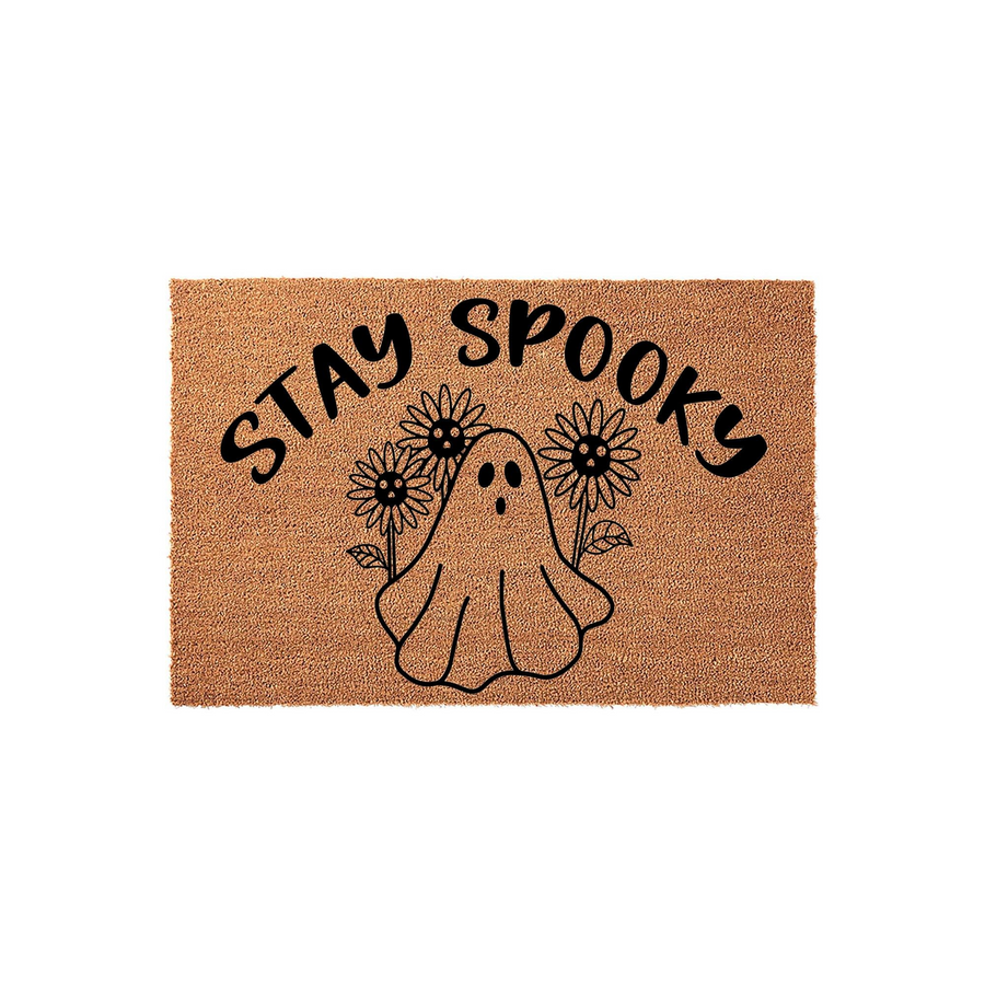 Stay Spooky ghost sunflower doormat featuring a cute illustrated ghost surrounded by flowers on a natural coir fiber background, making this a fun and festive Halloween front porch decor piece for your home entrance during the