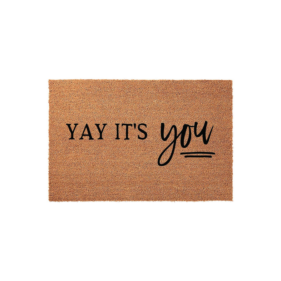 Yay It's You Coir Doormat featuring a natural brown fiber texture with bold black lettering that reads Yay It's You in a mix of modern serif and script fonts, creating a welcoming entryway accent for your front porch or home