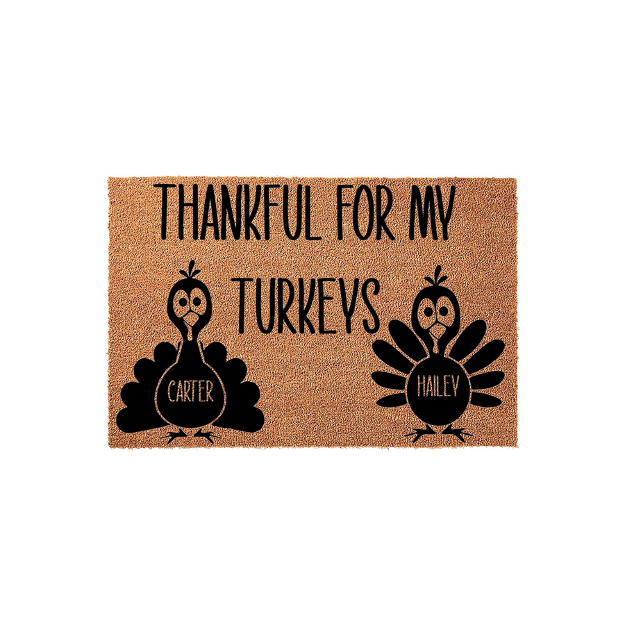 Personalized Thanksgiving doormat featuring two black turkey illustrations on a natural coir background, with the text Thankful For My Turkeys printed above them to celebrate the fall season with custom family names on each