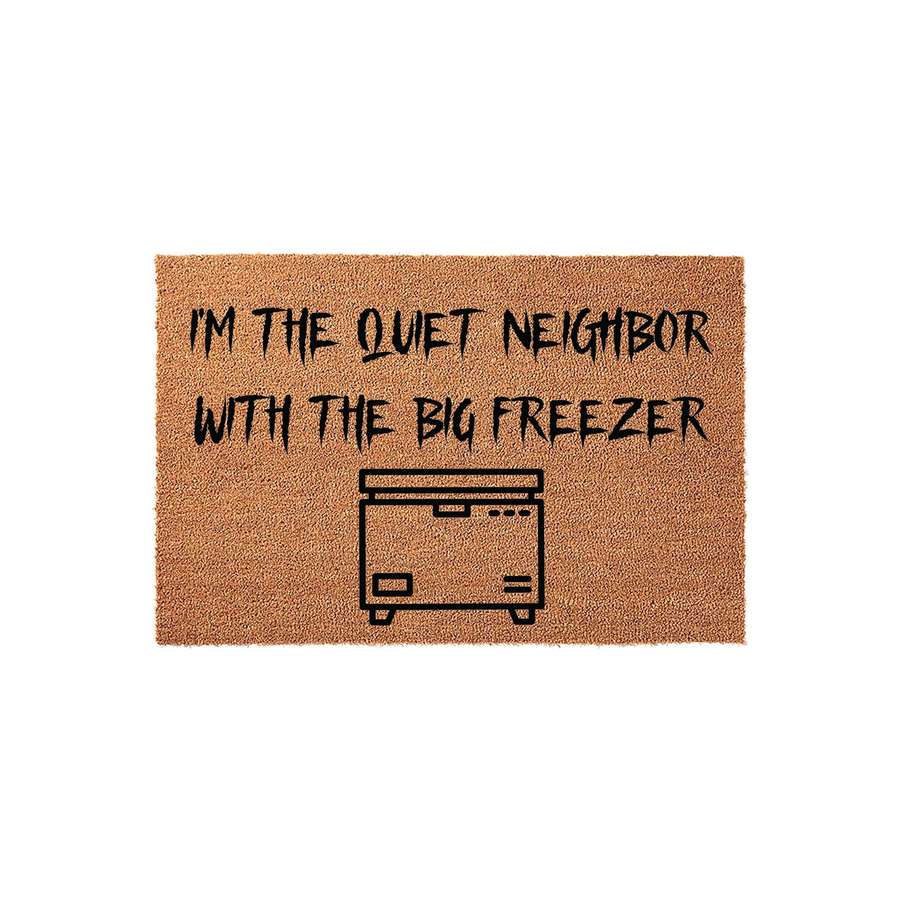 Funny Horror Themed Doormat featuring the text I'm the quiet neighbor with the big freezer in a spooky font, displayed on a natural coir fiber mat with a simple black line art illustration of a chest freezer centered below the