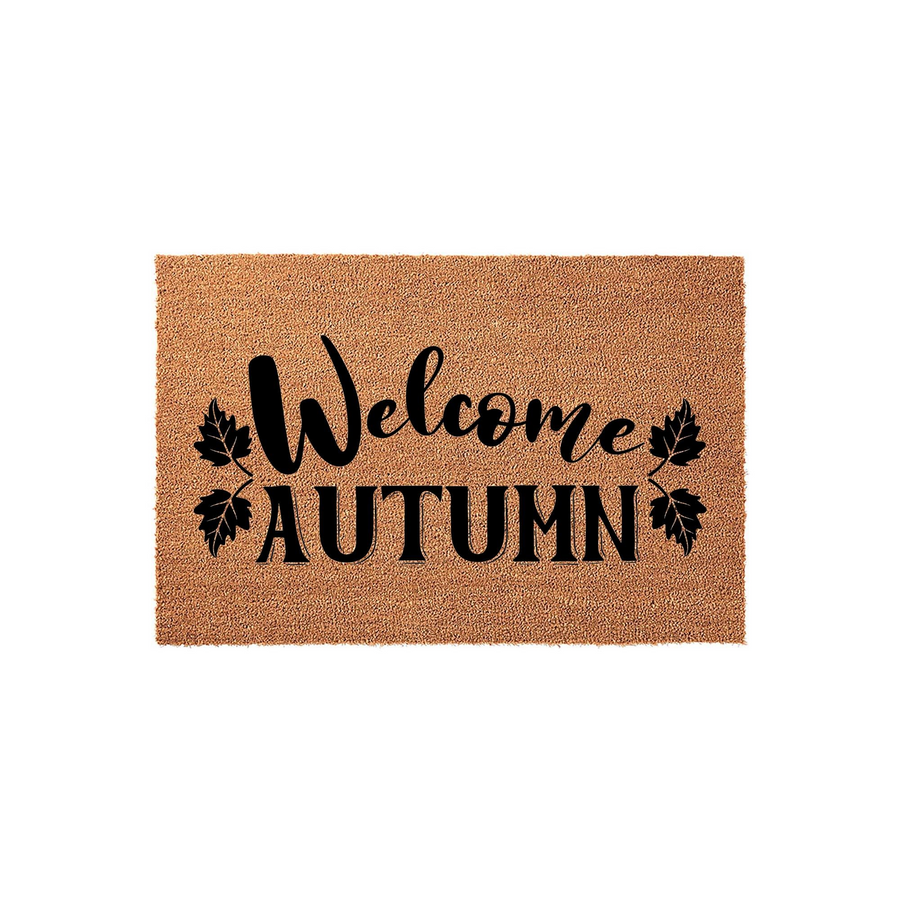 Welcome Autumn coir doormat featuring a natural brown fiber texture with black script lettering and decorative leaf accents, providing a festive seasonal entryway decor piece for your front porch during the fall harvest season.