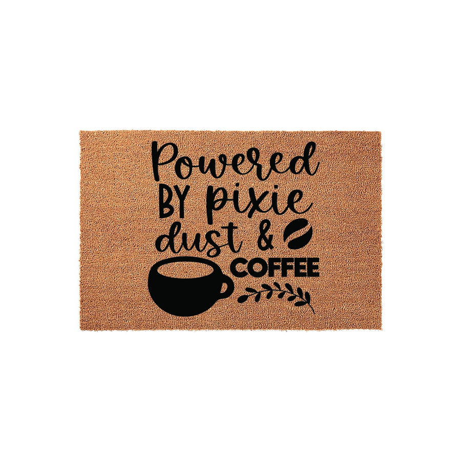 Powered by Pixie Dust and Coffee coir doormat featuring a natural brown fiber texture with black printed text and a graphic of a steaming coffee mug, creating a fun and welcoming entrance for any home or kitchen entryway decor.