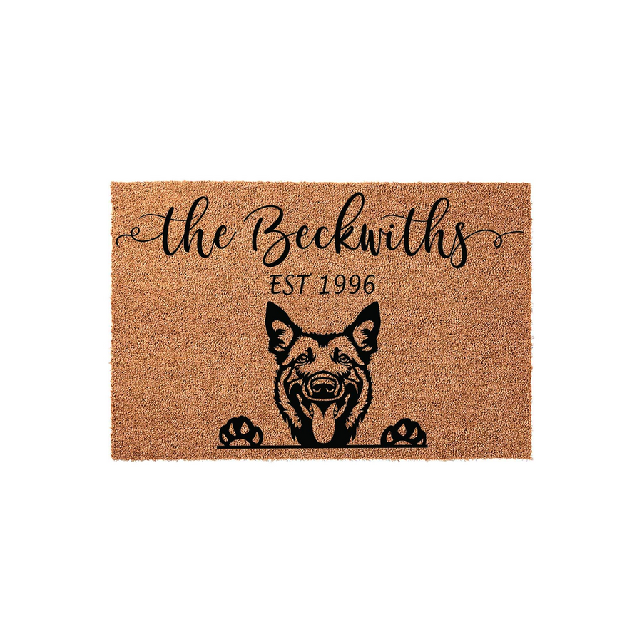 German Shepherd Personalized Doormat featuring a natural coir texture, displaying a custom family name and established year above a cute illustration of a dog peeking over the bottom edge on a clean white background for home