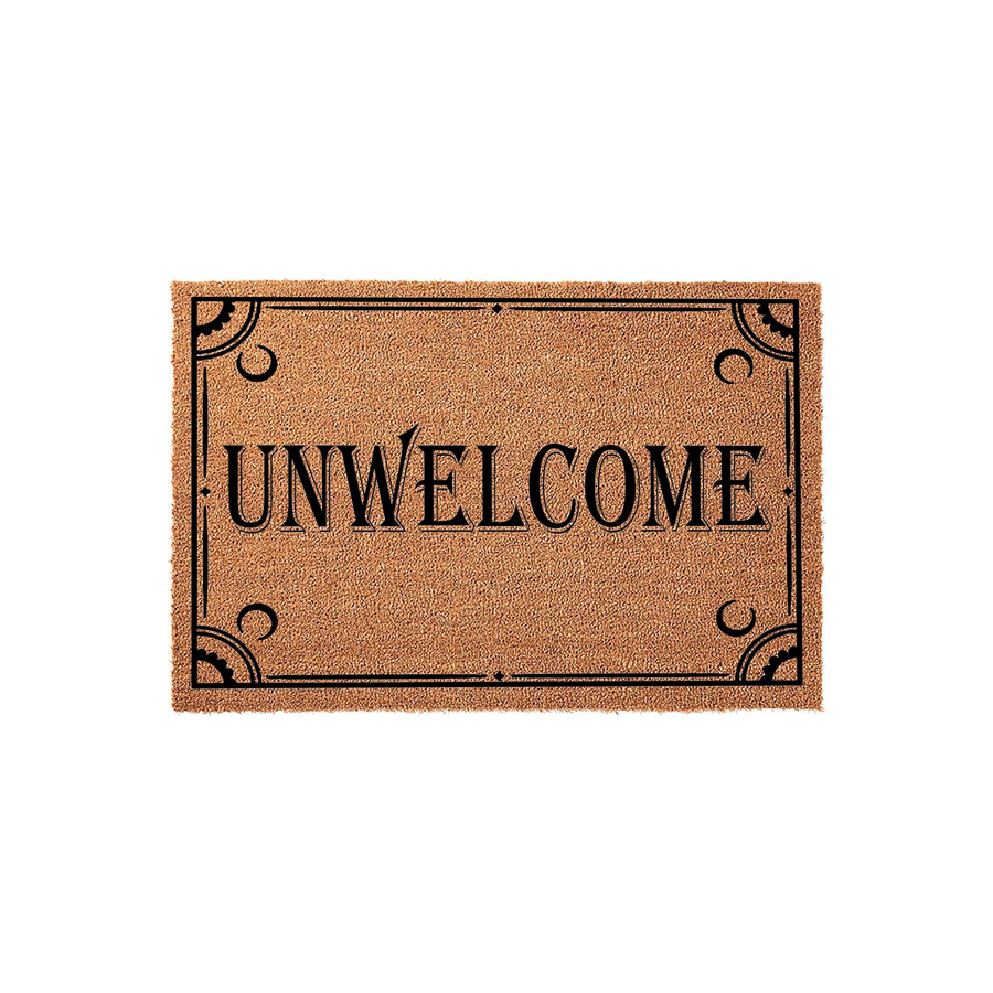 Unwelcome coir doormat featuring a humorous, bold black text design centered on a natural brown fiber mat, framed by elegant decorative corner flourishes that add a touch of gothic style to your front porch or entryway decor.