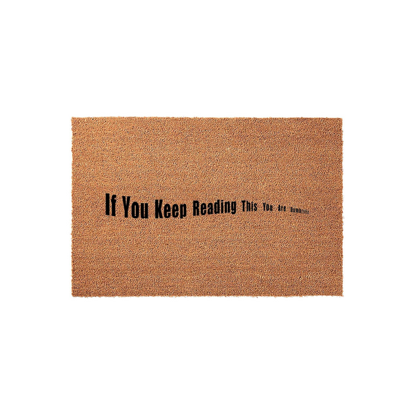 Funny Coir Doormat with the text If You Keep Reading This You Are Dumb printed in black ink on a natural brown fiber surface, featuring a humorous design that makes for a witty and sarcastic welcome mat for your front porch or