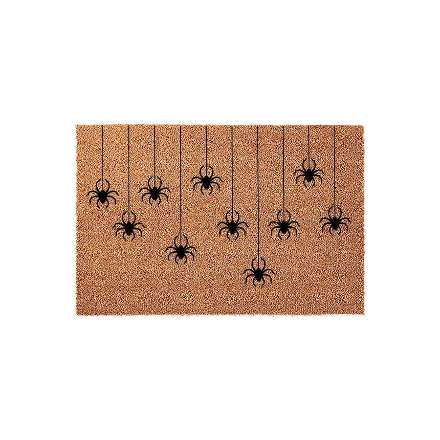 Halloween spider doormat featuring a natural coir texture with a pattern of black spiders hanging from thin vertical lines, creating a spooky and festive entryway decor piece for the fall season on a plain white background.