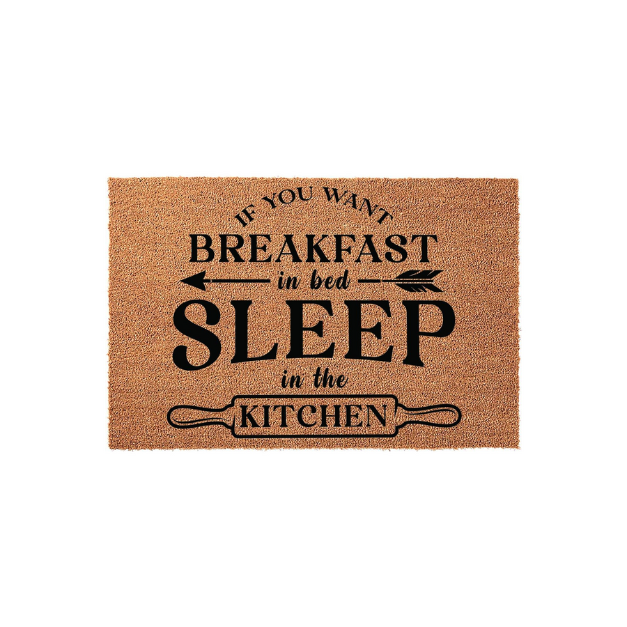 Funny Kitchen Doormat with a natural coir texture, featuring the humorous black text If You Want Breakfast in Bed Sleep in the Kitchen with a rolling pin graphic, displayed on a clean white background for a modern home decor