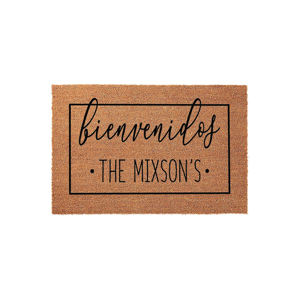 Personalized Bienvenidos coir doormat featuring a rectangular black border and custom family name text in a modern script and sans-serif font, set against a clean white background for a welcoming front porch entrance decor style.