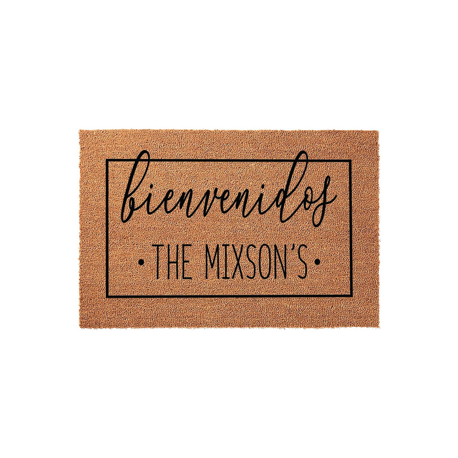 Personalized Bienvenidos coir doormat featuring a rectangular black border and custom family name text in a modern script and sans-serif font, set against a clean white background for a welcoming front porch entrance decor style.