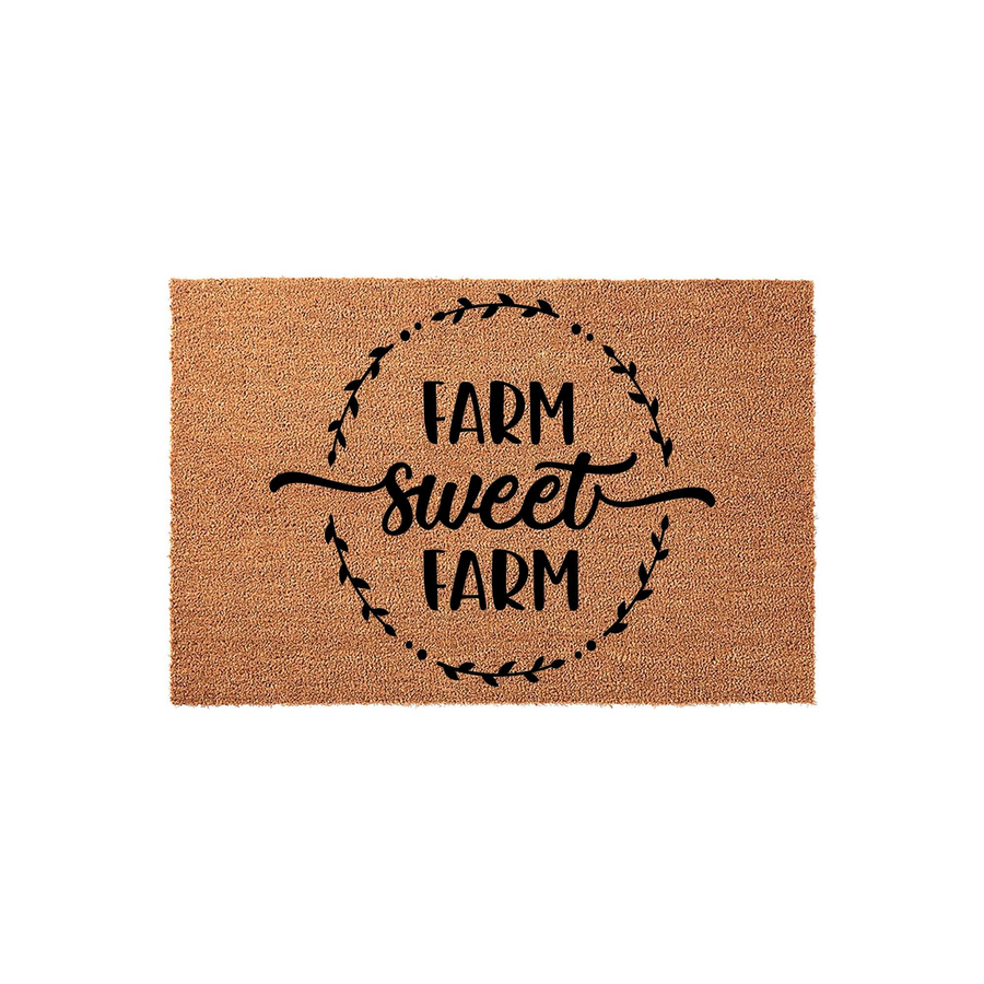 Farm Sweet Farm coir doormat featuring a rustic farmhouse aesthetic with black text and a decorative leaf wreath design printed on a natural brown coconut fiber mat, perfect for a welcoming front porch or entryway decor.
