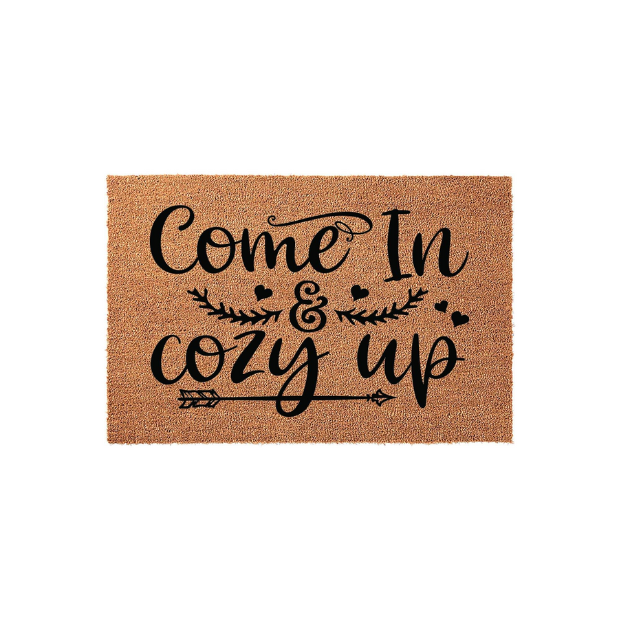 Come In and Cozy Up coir doormat featuring a natural tan fiber texture with black printed text, decorative arrow accents, and small hearts, creating a welcoming farmhouse style entrance for your front porch or home entryway.