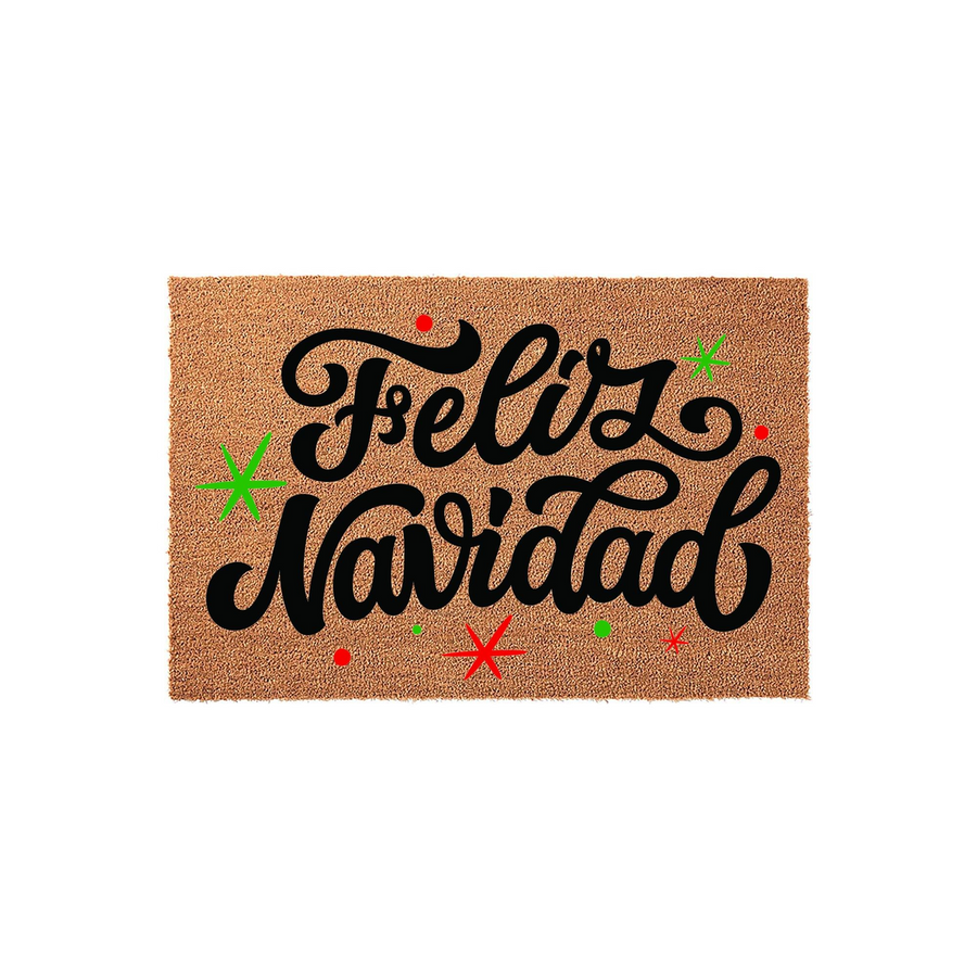 Feliz Navidad coir doormat featuring festive black script lettering on a natural tan fiber background, accented with small red and green holiday stars and dots for a cheerful seasonal welcome to your front porch entryway.