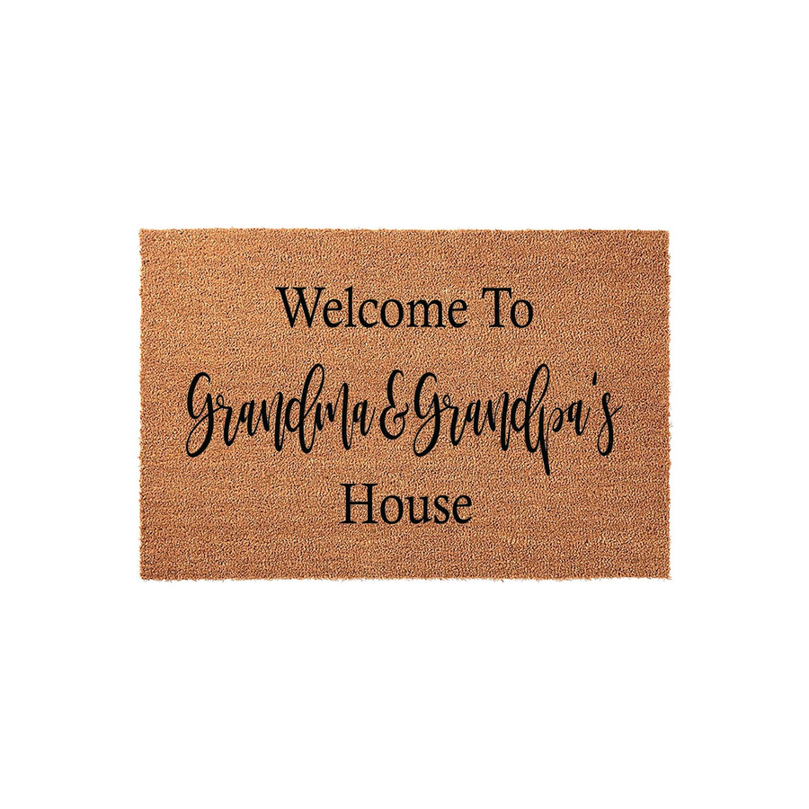 Grandma and Grandpa's House coir doormat featuring a natural tan fiber texture and bold black lettering that reads Welcome To Grandma & Grandpa's House, making it a charming addition to any front porch or entryway decor.