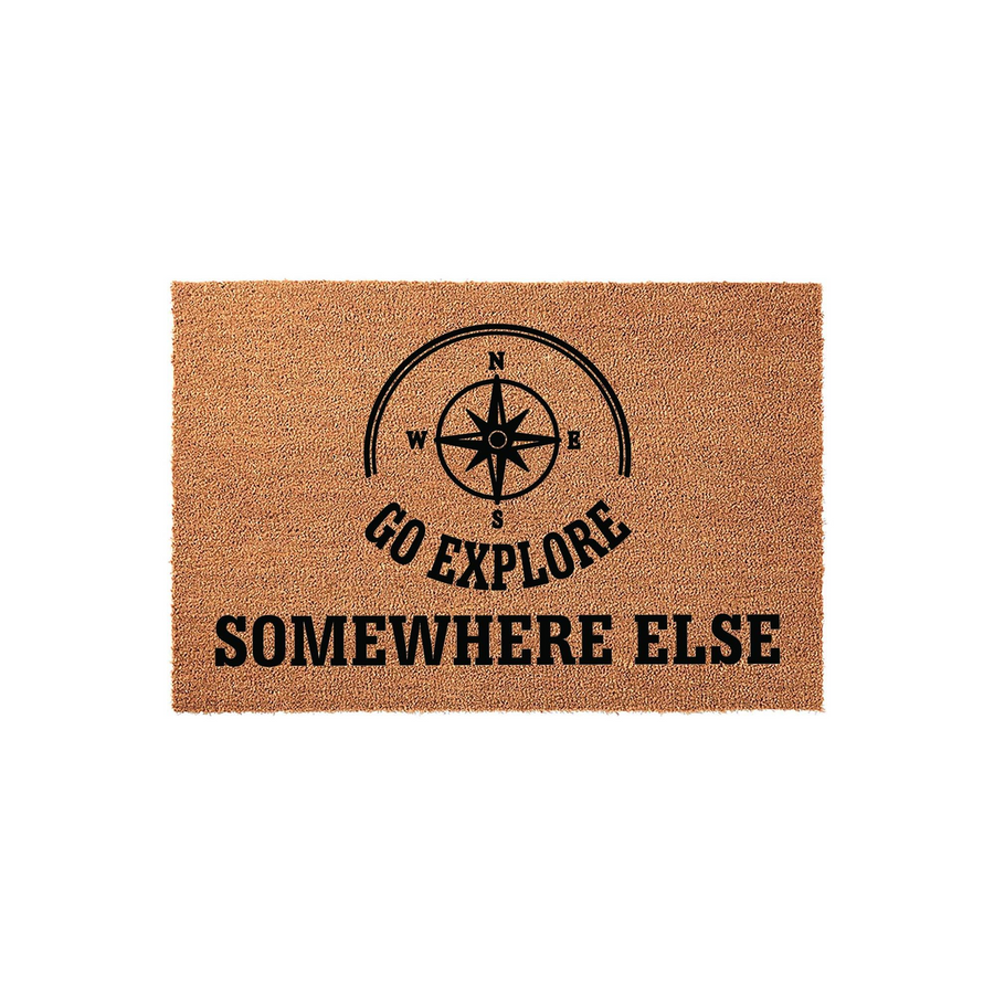 Go Explore Somewhere Else coir doormat featuring a black compass rose graphic printed on a natural brown textured fiber surface, creating a humorous and adventurous welcome mat for your front porch or entryway decor.