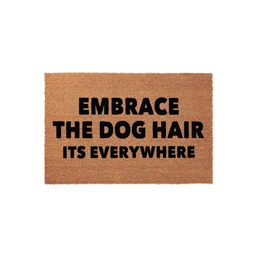 Funny Dog Lover Doormat featuring a natural coir texture with bold black text that reads Embrace The Dog Hair Its Everywhere, making it a humorous and practical home decor accessory for any pet owner who loves their furry canine