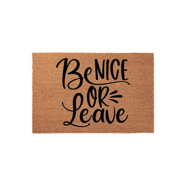 Be Nice Or Leave coir doormat featuring bold black hand-lettered typography centered on a natural brown fiber mat, creating a funny and welcoming front porch entrance decor piece for your home or apartment entryway.