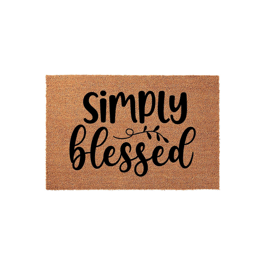 Simply Blessed coir doormat featuring a natural tan fiber texture and bold black script lettering, centered on a clean white background to provide a welcoming and rustic farmhouse aesthetic for your front porch entryway decor.