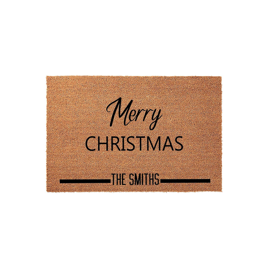 Personalized Merry Christmas coir doormat featuring a natural brown fiber texture with black printed text that includes a festive holiday greeting and a customizable family name line for a welcoming front porch entrance decor.