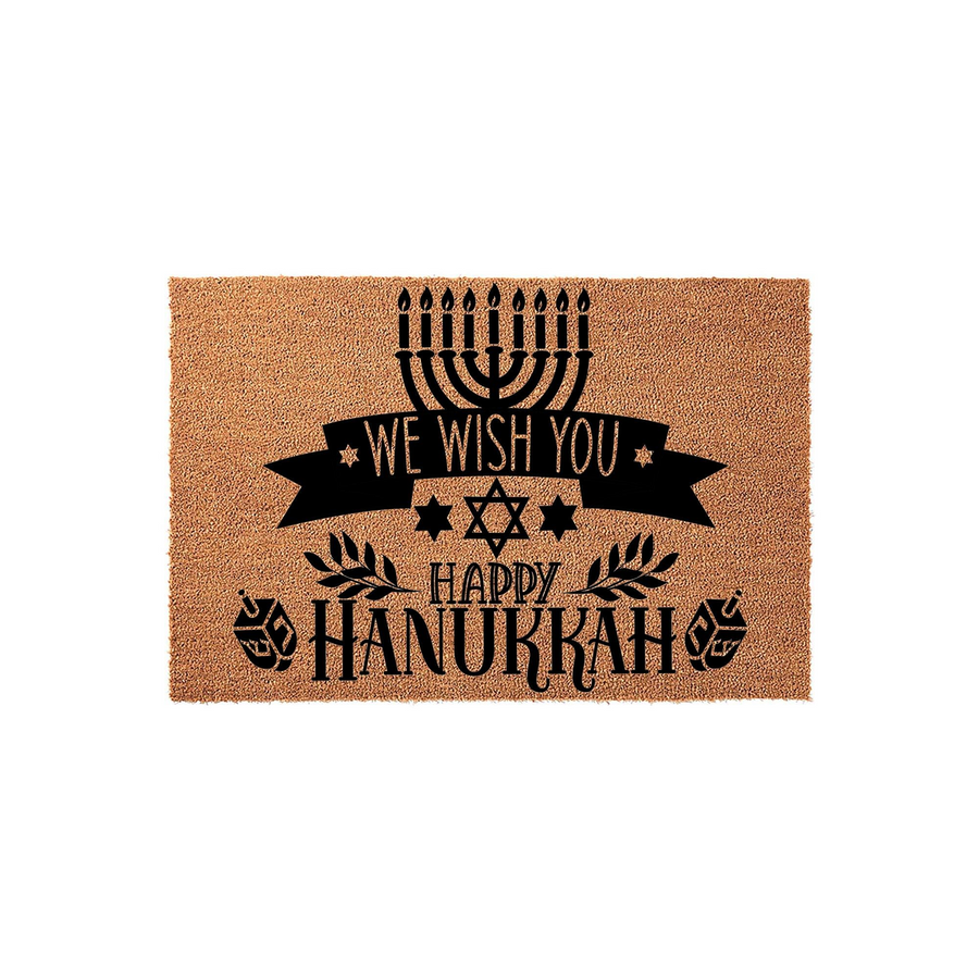 Hanukkah coir doormat featuring a black printed design of a menorah, a Star of David, and dreidels with the text We Wish You Happy Hanukkah, set against a natural tan textured fiber background for a festive holiday entryway