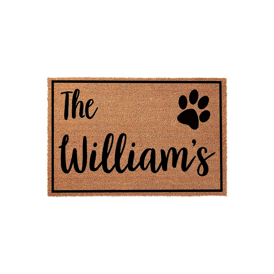 Personalized pet lover coir doormat featuring a black paw print icon and custom family name text in a stylish script font, set against a natural tan textured background with a clean black border for a modern home entryway look.