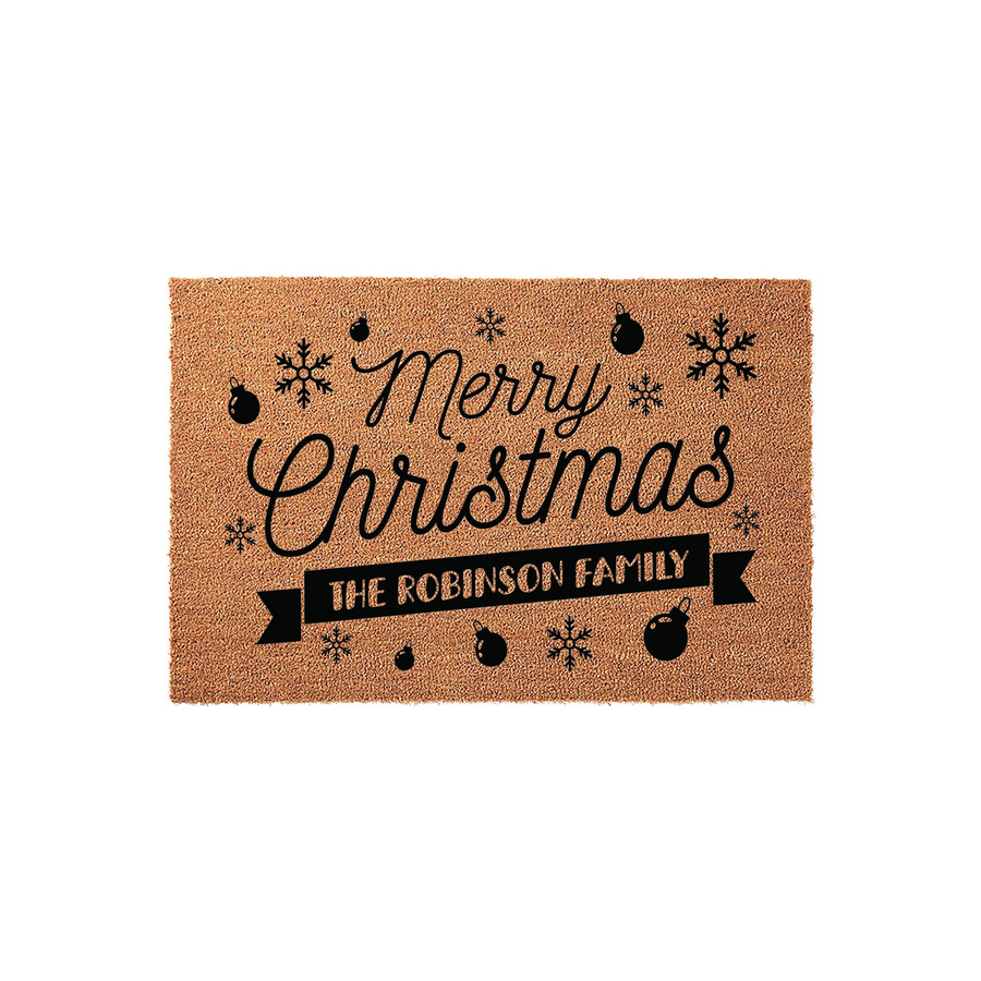 Personalized Merry Christmas coir doormat featuring black festive ornaments and snowflake illustrations, with a custom banner at the bottom that displays a family name for a welcoming holiday entrance to your home.