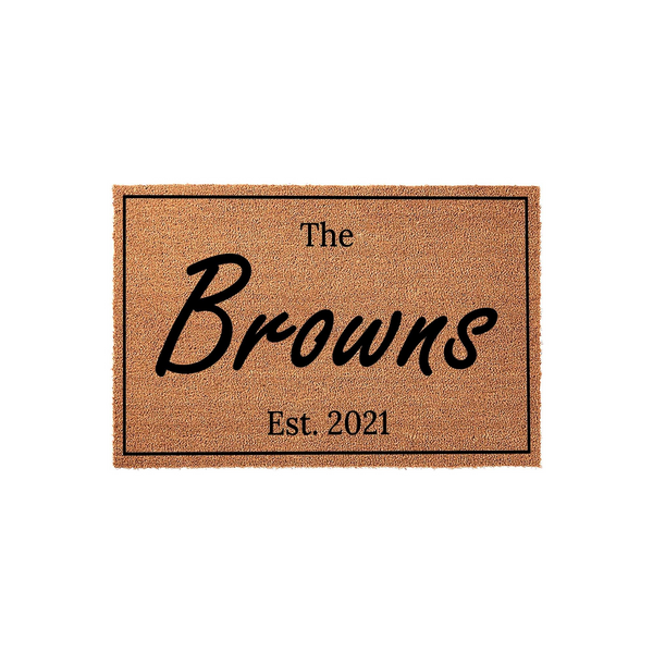 Personalized family name coir doormat featuring a classic rectangular border and custom text in a stylish script font, providing a welcoming entrance for any home with its durable natural fiber construction and clean design.