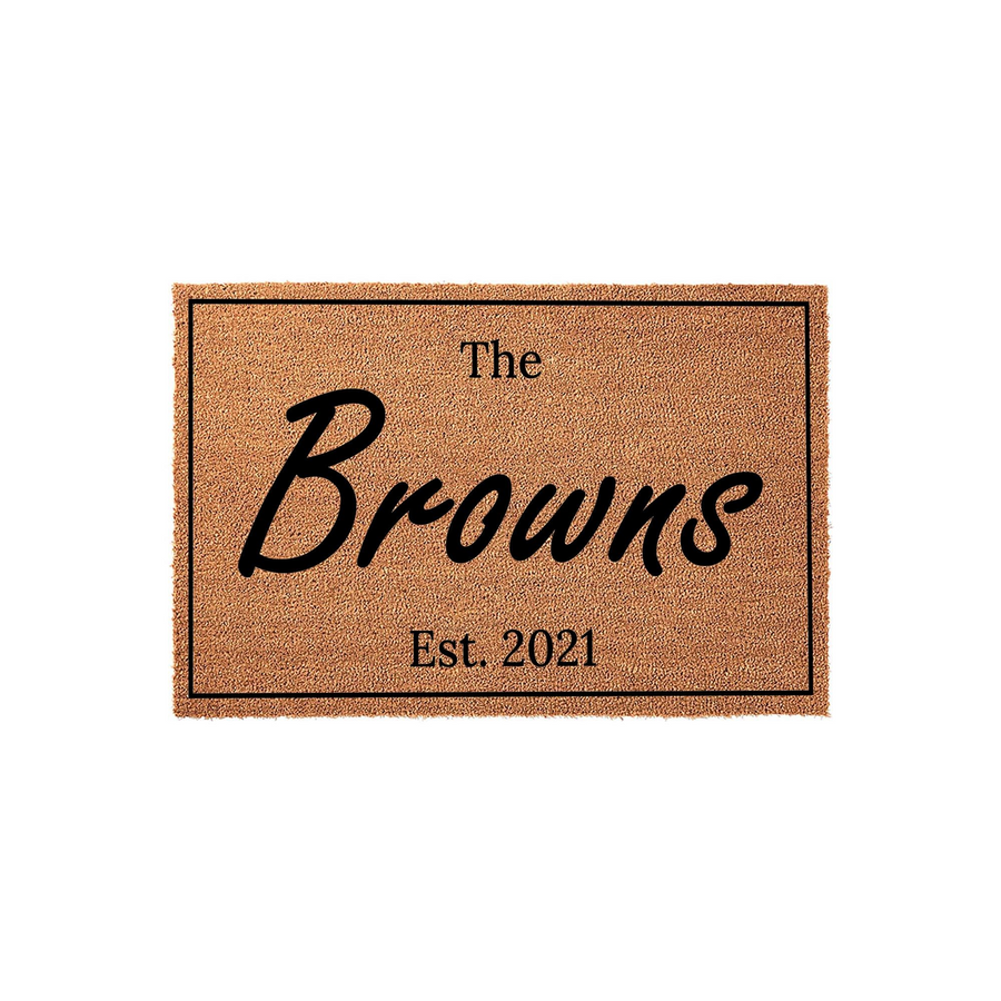 Personalized family name coir doormat featuring a classic rectangular border and custom text in a stylish script font, providing a welcoming entrance for any home with its durable natural fiber construction and clean design.