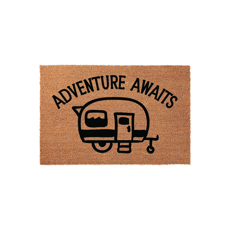 Adventure Awaits camper doormat featuring a natural coir texture and a bold black graphic of a vintage travel trailer, making it a fun and durable outdoor welcome mat for any camping enthusiast or RV owner looking to decorate