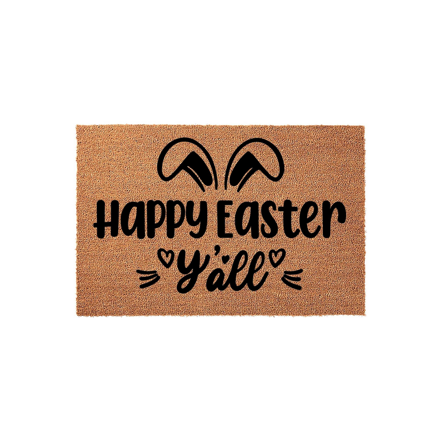 Happy Easter Y'all coir doormat featuring black printed text and cute bunny ears, set against a plain white background to highlight the natural fiber texture and festive spring holiday design for your front porch entryway decor.